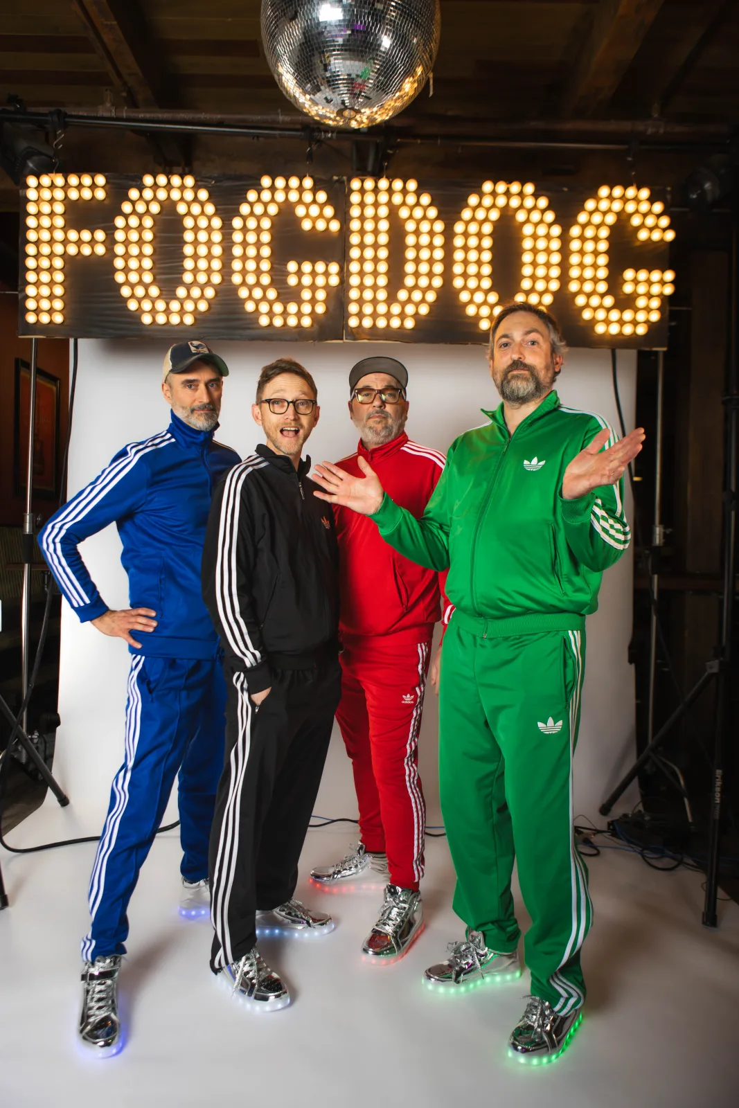 FOGDOG members in tracksuits beneath the dot-matrix wordmark.